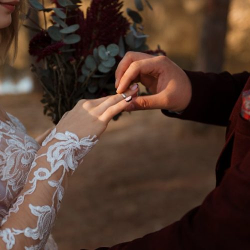 side-view-bride-wearing-wedding-ring-min